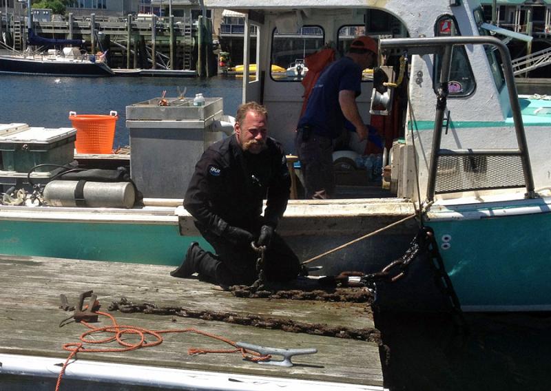 Lobsterman and diver Toby Wincklhofer at work on a float in Camden Harbor. (Photo by Steve Pixley)