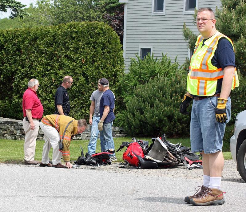 Luckily for both drivers, all that's left after Monday morning's accident on Mill Street is to pick up the broken pieces of motorcycle. (Photo by Holly S. Edwards)