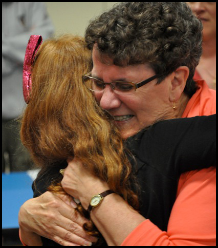 Carol Hathorne hugging a student, saying goodbye.