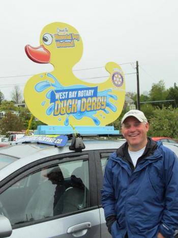 Peter Berke was a good sport and agreed to put a duck on his car to publicize the June 1 West Bay Rotary Duck Derby. (Photo Kay Stephens)