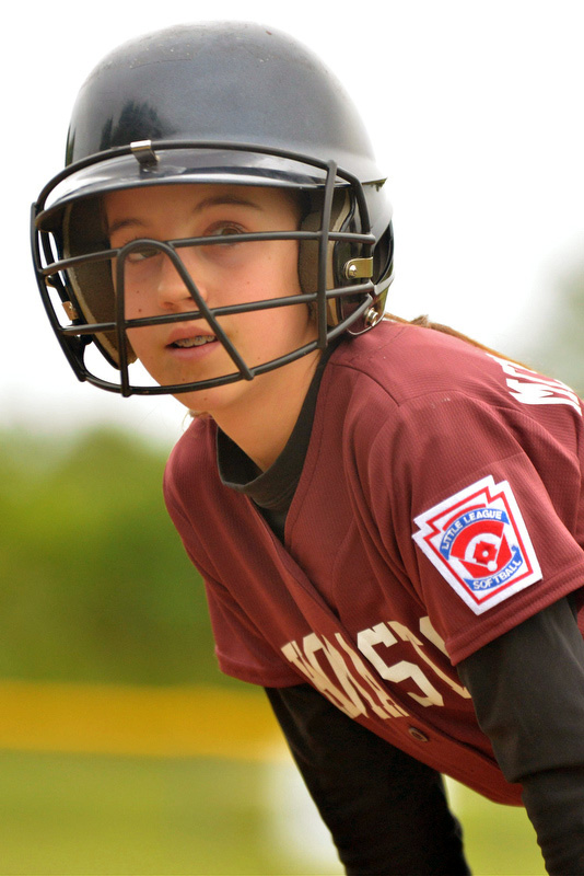McMahon's Abby Veilleux talks with her coach at first base. (Photo by Ron Hawkes)