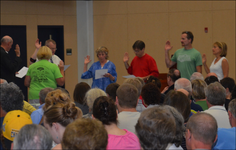 At the beginning of town meeting, elected selectmen and committee members are sworn in.