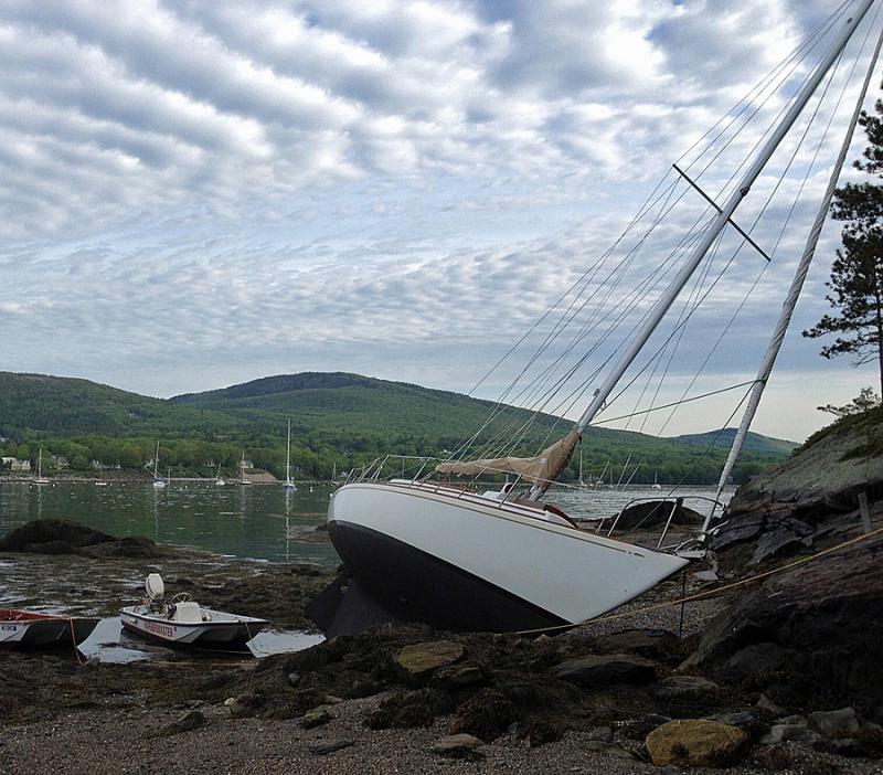 Camden Harbormaster Steve Pixley's whaler floats next to the 30-foot sailboat 'Providence' Thursday morning, which is when it was found beached on the one spit of sandy beach on Curtis Island in the outer harbor. (Courtesy Steve Pixley)