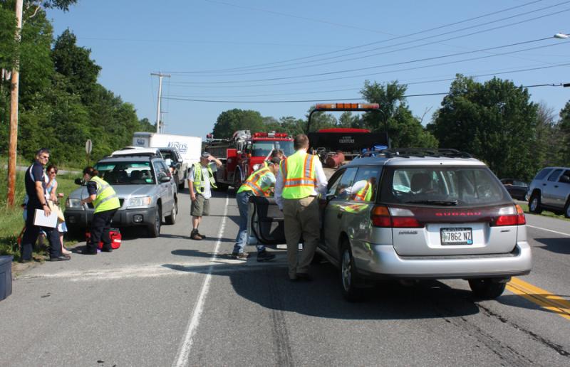 North East Mobile Health crewmembers talk to Jean Curtin, left, after she crashed her car into the back of a pickup truck on Route 17 in Rockport Wednesday morning. (Photo by Holly S. Edwards)