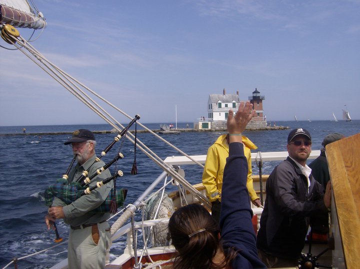 Capt. Ken Barnes, left, on the bagpipes, while his son, Capt. Noah Barnes, now runs the family windjammer Stephen Taber (Photo by Kay Stephens)