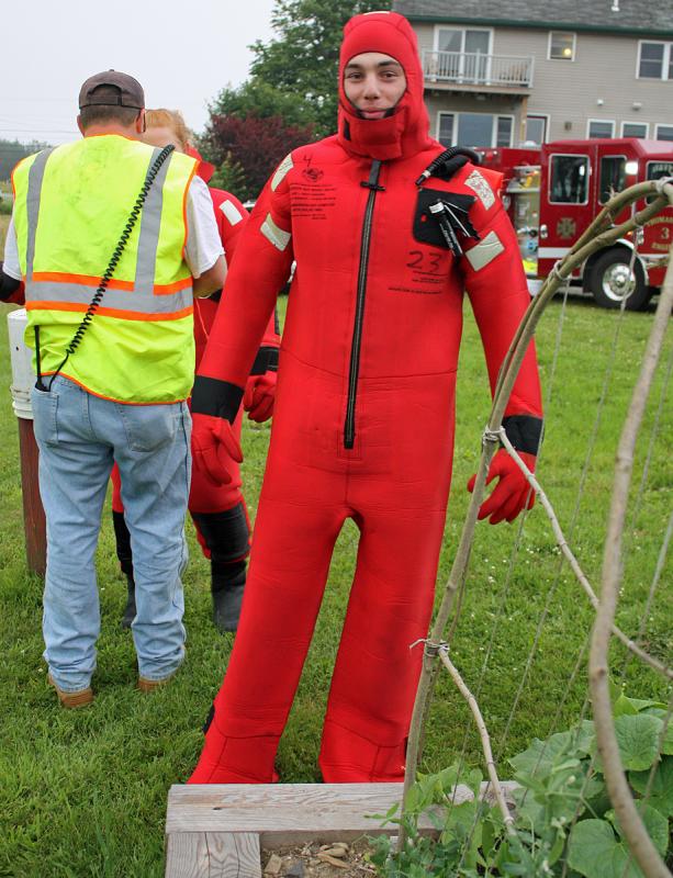 Colby Miles, looking and feeling a bit like Gumby, will be warm and dry in this survival suit when heads into the Weskeag River during training. (Photo by Holly S. Edwards)