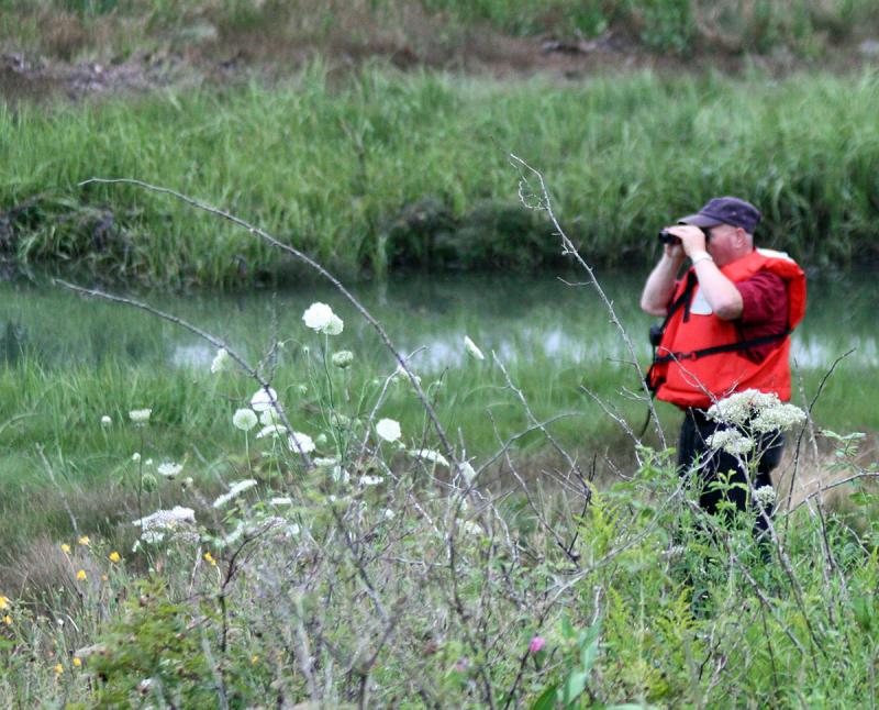 South Thomaston Lt. Robert Grierson scans the river in search of the other two 'missing' boaters they need to find during this training. (Photo by Holly S. Edwards)
