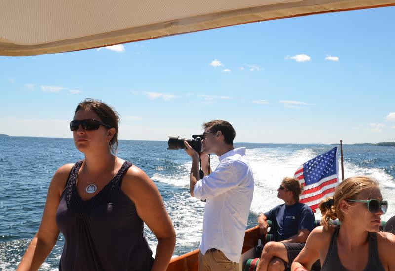 Watching and photographing the race from the Osprey. (Photo by Lynda Clancy)
