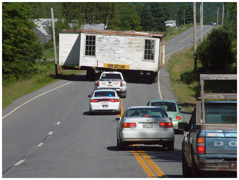 The old school house slowed traffic in both directions on Route 137 Monday morning during the move. (Photo by Ethan Andrews)