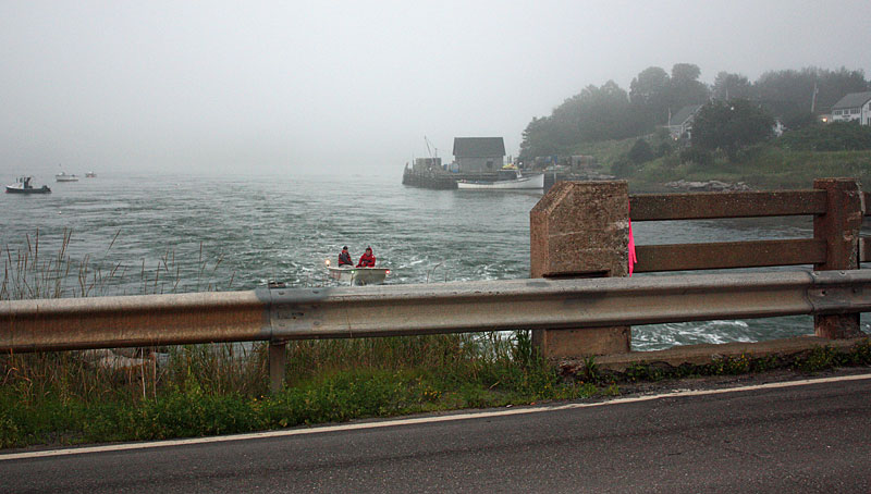 Firefighters still floating vigil in case someone goes under the Route 73 bridge on the Weskeag River during firefighter water rescue training. (Photo by Holly S. Edwards)
