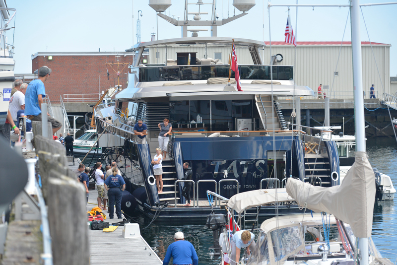 People from the yacht TATS wait while law enforcement searches for a missing diver that was working on the TATS. (Photo by Ron HAwkes)