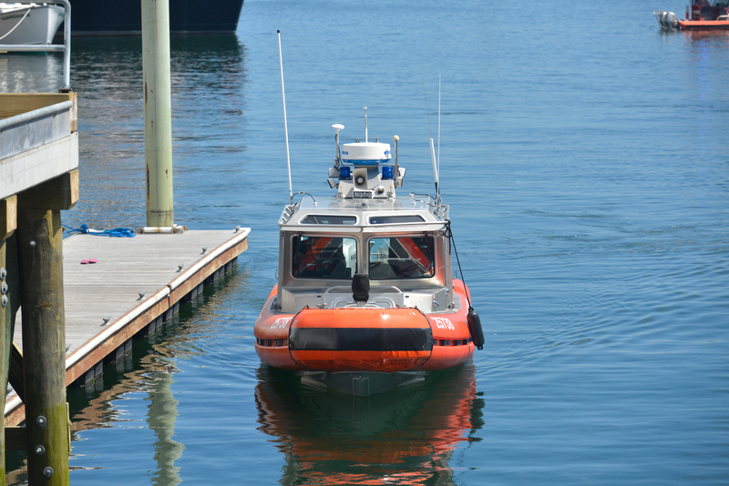 A Coast Guard boat slowly searches the inner harbor Sunday. (Photo by Ron Hawkes)