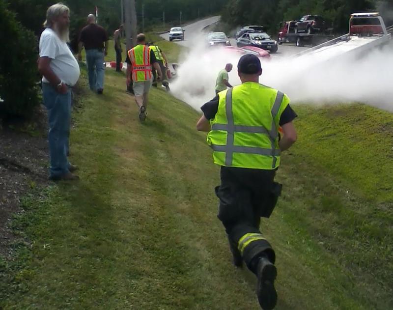 Waldoboro firefighters respond to an accident on Route 1 in Waldoboro, where a Toyota sedan caught fire. (Photo by Mike Scarborough)
