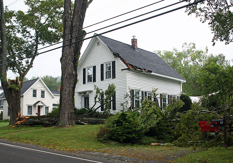 This large tree limb at a Washington Street residence came to rest on a pickup truck in the driveway, but also took out a corner of the roof of the home. (Photo by Holly S. Edwards)