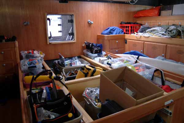 With the comfortable queen-sized bed removed, the aft cabin becomes storage for four month's worth of emergency equipment. The clear hatch at the back is designed to be an escape route for Stanley Paris, should Kiwi Spirit capsize. (Photo by Shlomit Auciello)