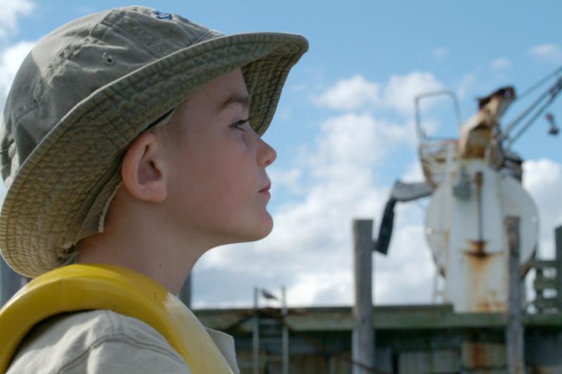 Noah Clayton, 5, of Rockland, takes a turn at the wheel at the "Two Toots" harbor launch. (Photo: Shlomit Auciello)