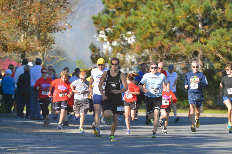 The starting canon was fired and Darren Winchenbach, No. 2 center, led the runners out of the gate and into the finish has he led all the way and was the only runner to finish in under 20 minutes. (Photo by Ron Hawkes)