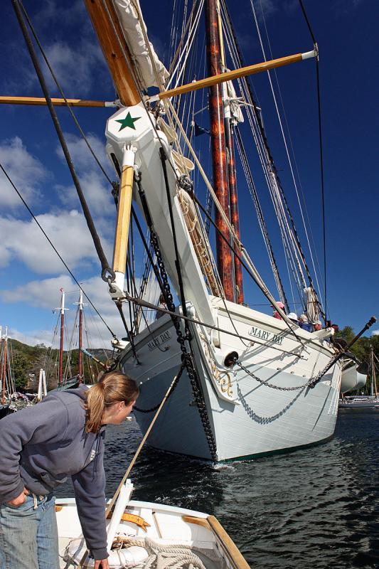 Becca Johnson uses the yawl boat, ‘Arno’ to tow schooner ‘Mary Day’ out of Camden’s inner harbor Sept. 26. (Photo by Holly S. Edwards)