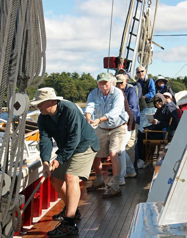 Up on deck, crew and passengers work together to hoist the sails on ‘Mary Day.’ (Photo by Holly S. Edwards)