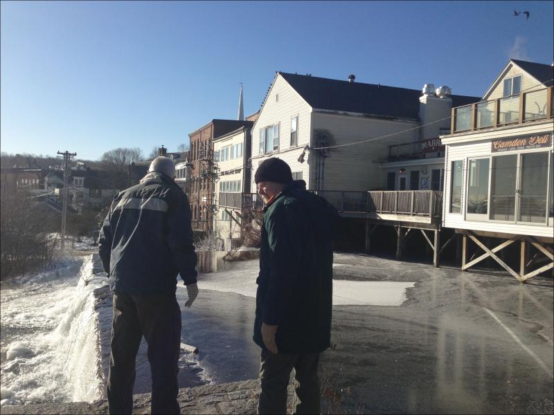 Camden’s Waste Water Plant Superintendent and Maine Department of Environmental Protection’s Dan Davis stand at the top of the Montgomery Dam during an oil spill incident that occurred last winter. (Photo by Lynda Clancy)