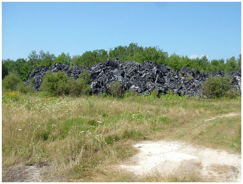Piles of the synthetic fiber left unexposed on the back lot of an abandoned shooting range on Route 90 in Warren. (Photo by Ethan Andrews)