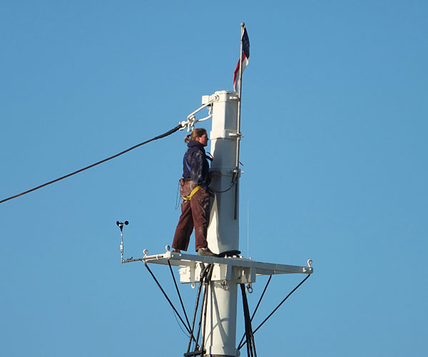 A deckhand from the Mary Day works aloft before the boat is shrink-wrapped.