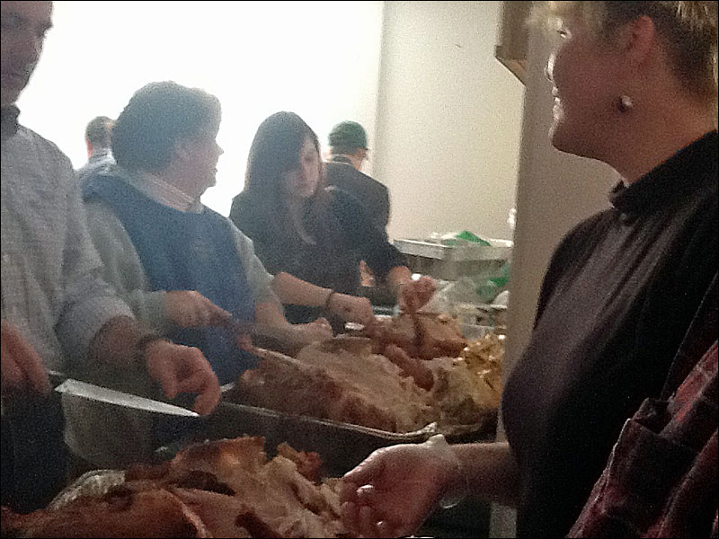 Many hands make quick work picking the turkey meat and when that job is finished, it’s time to eat. (Courtesy Bill Packard)