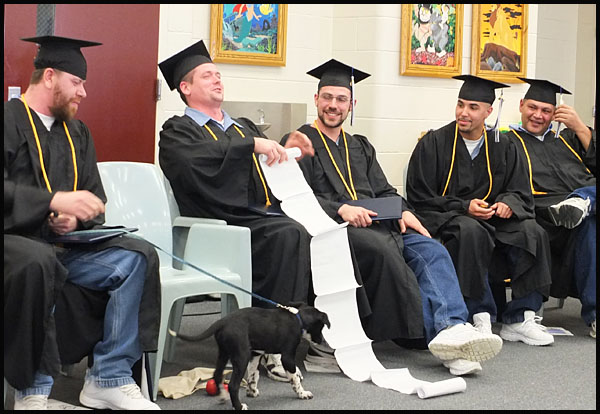 Steven M. Clark rerolls his notes after his comments following graduation.