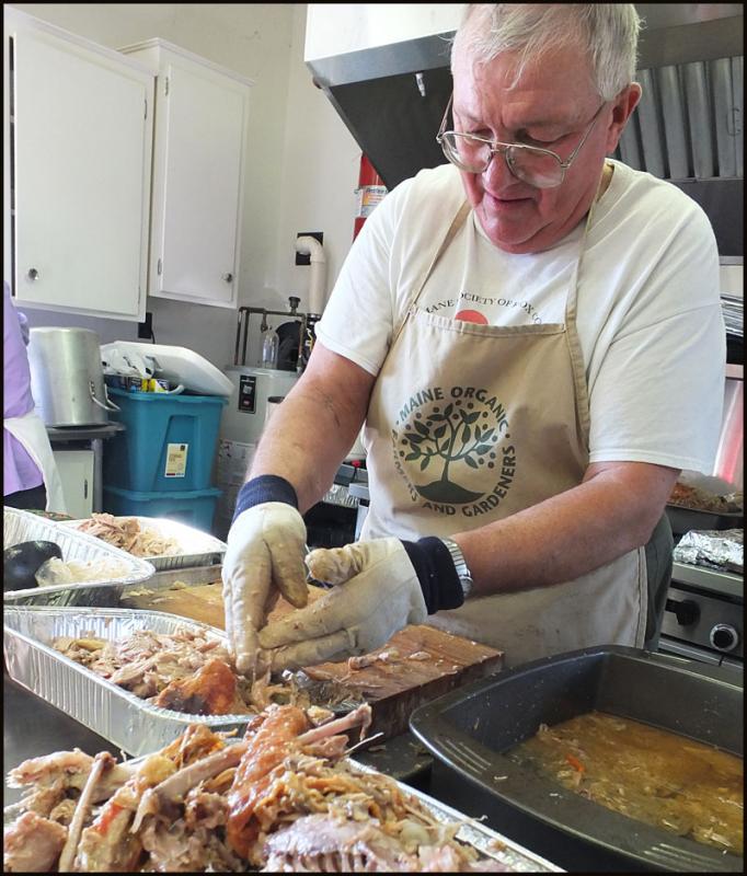 Peter Lammert picks turkey for the dinner in Thomaston.