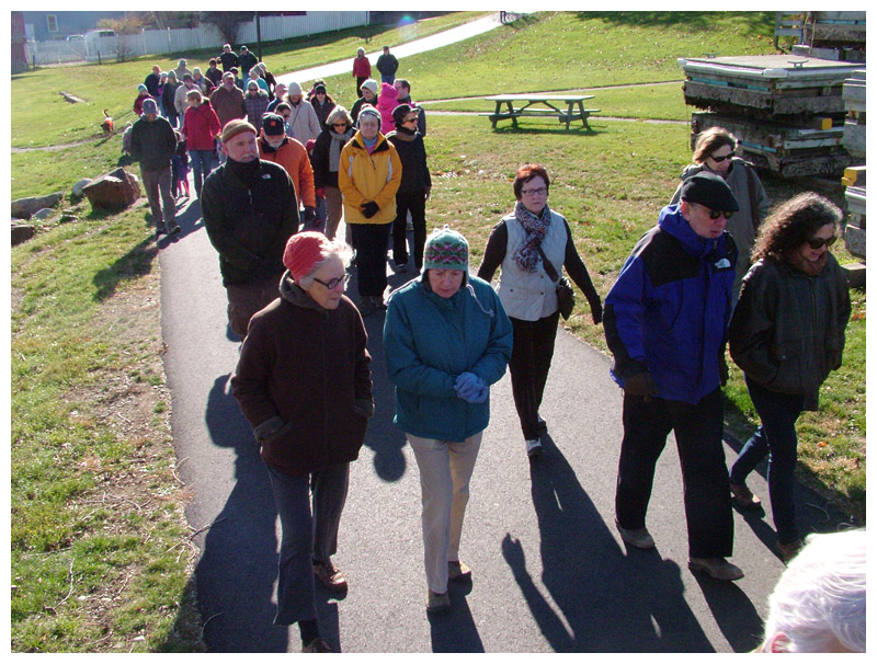 The group marches north through Heritage Park on the way to the trail’s end at the Armistice footbridge. (Photo by Ethan Andrews) The group marches north through Heritage Park on the way to the trail’s end at the Armistice footbridge. (Photo by Ethan Andrews)