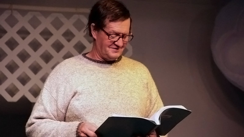 Doug Brown of Belfast reads from a book of his poems, many of which are based on chance observations. (Photo by Wes Sterrs)