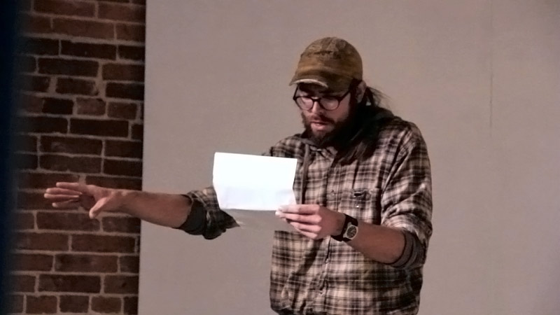 Josh Kauppila of Belfast reads one of over a dozen poems during a variation on a poetry slam, Nov. 22. (Photo by Wes Sterrs)