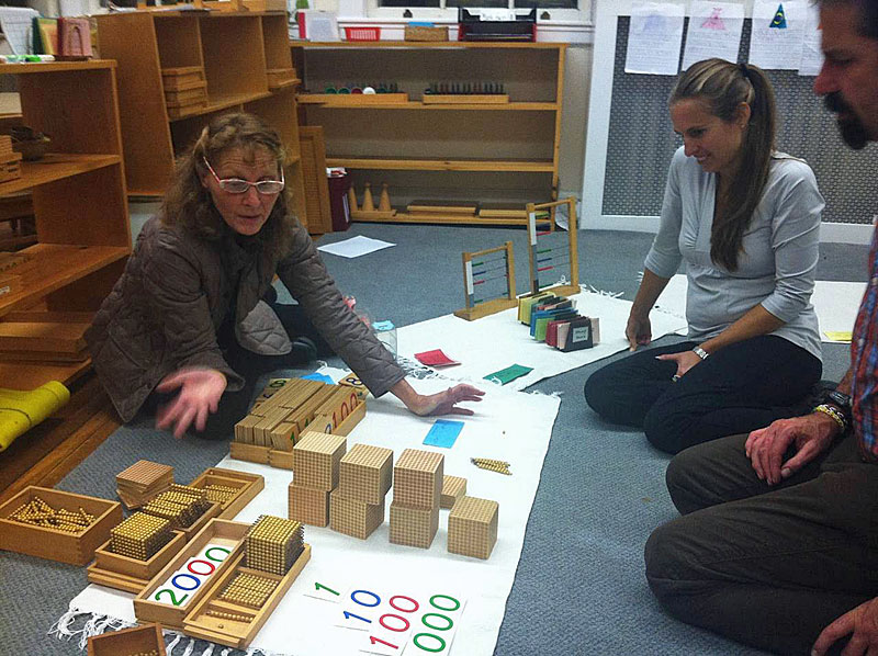 Jade Door (primary) co-teacher Katy Hall Dermott shares math materials with parents. (Courtesy Children's House Montessori School)