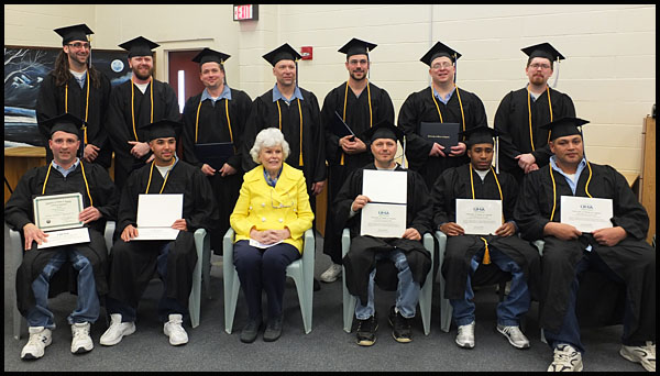 Doris Buffett (center) sits with the 2013 graduating class. The graduates are, in no particular order, Jerry James Banks, Brandon Sobosie Brown, Steven M. Clark, Jon James Dow, Sergio Stephen Haitston, Robert Alan Payzant, Daniel P Roberts, Dale Allen Wood, Jon Brent Dyer, Edwin Devaughn Keys, Victor E. Loveitt, Joseph Billings Rouleau and Christopher David Shumway.