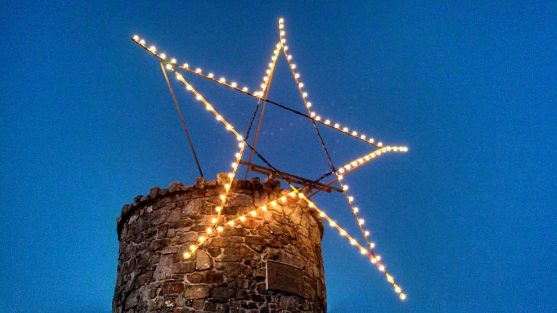 Every afternoon at dusk, from Thanksgiving Day night to New Year’s Eve, volunteers take turns traveling to the top of Mt. Battie to put 2-1/2 gallons of gasoline in the generator and flick the switch on the 100 light bulbs that illuminate the star atop the tower. It’s a sure sign of the holidays and is a welcome sight to anyone passing through, visiting or coming home to the Midcoast. (Courtesy Randy Stearns)