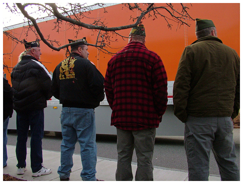 Veterans watch as the convoy of wreath-bearing trucks rolls into Belfast, Sunday. (Photo by Ethan Andrews)