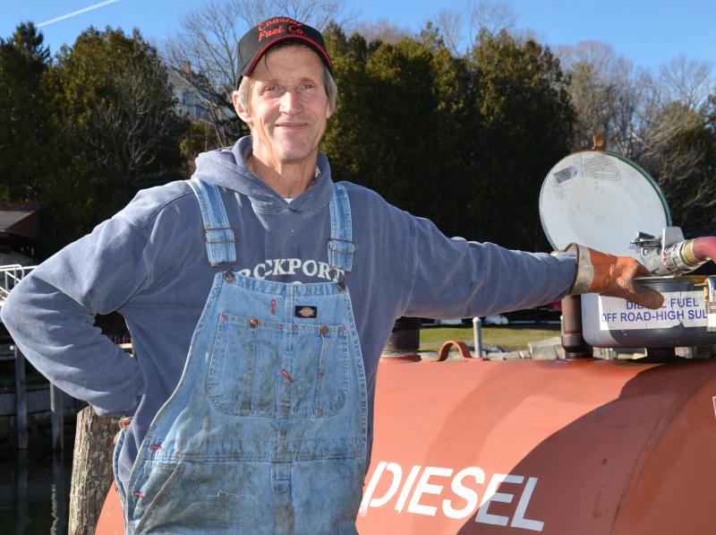 David Pettee works for Coastal Fuel and fills up the tank, from which lobstermen fill their boats with fuel. (Photo by Lynda Clancy) lobster boats Rockport Harbor Maine