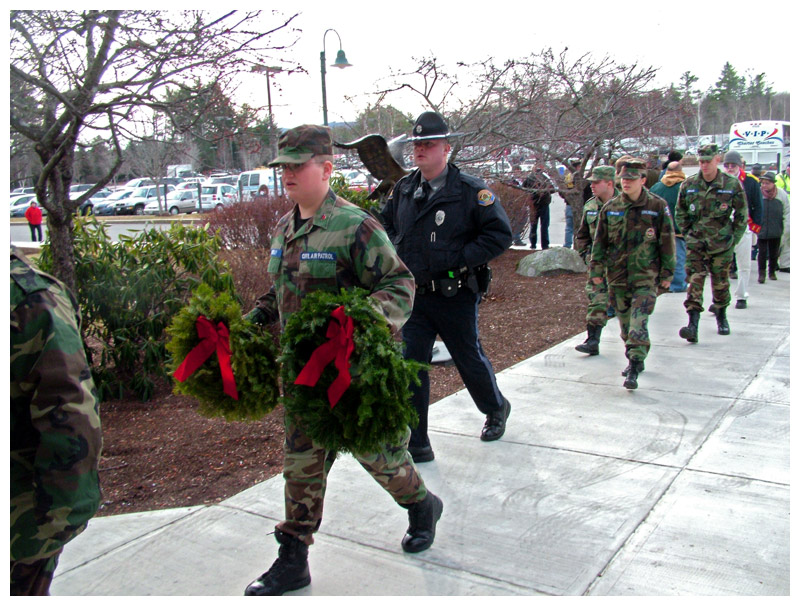 Soldiers file into the Bank of America in Belfast building bearing wreaths during a stopover on the way to Arlington, Va. (Photo by Ethan Andrews)