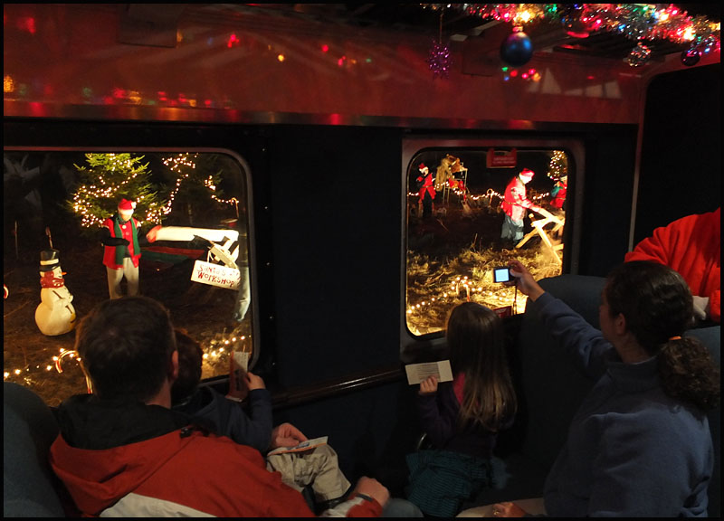 Riders of the Jingle Bell express view Santa's workshop through the train window Friday night, Dec. 6. (Photo by Chris Wolf)