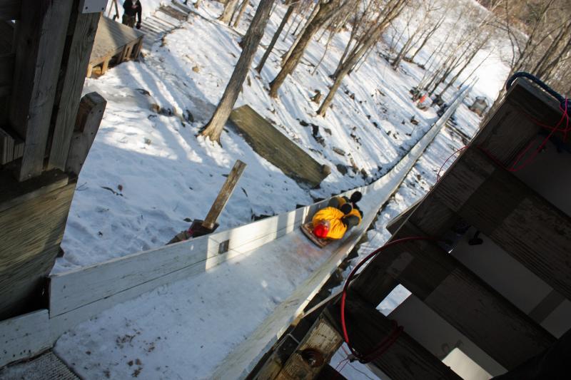 Reporters from Bangor Daily News, Courier Publications, WCSH 6, Sun Journal and WABI 5 all took turns sliding down the toboggan chute Jan. 31 for the U.S. National Toboggan Championships’ Media Day. (Photo by Holly S. Edwards)