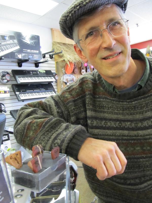 Chris Gray next to some of his picks at K2 Music. Photo by Kay Stephens