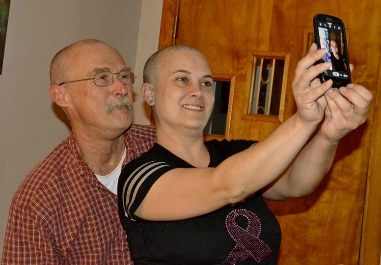 Michelle Robicheau Winchenbach of Waldoboro (right) and her father Joseph Robicheau of Warren (left) shave their heads prior to the start of her chemotherapy treatments. (Photo courtesy of Leanne M. Robicheau)