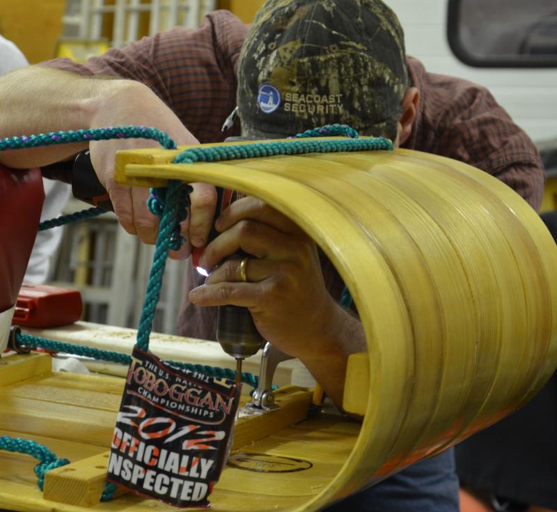 Matt Haynes gets the sled into shape with a few new screws. (Photo by Lynda Clancy)