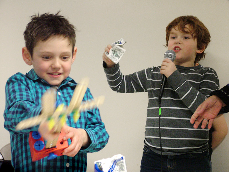 Gabe Hatfield, left, and Devlin Jones demonstrate a milk carton compactor made from Tinker Toys. The project was one of several examples project-based learning demonstrated by Searsport second-graders. (Photo by Ethan Andrews)