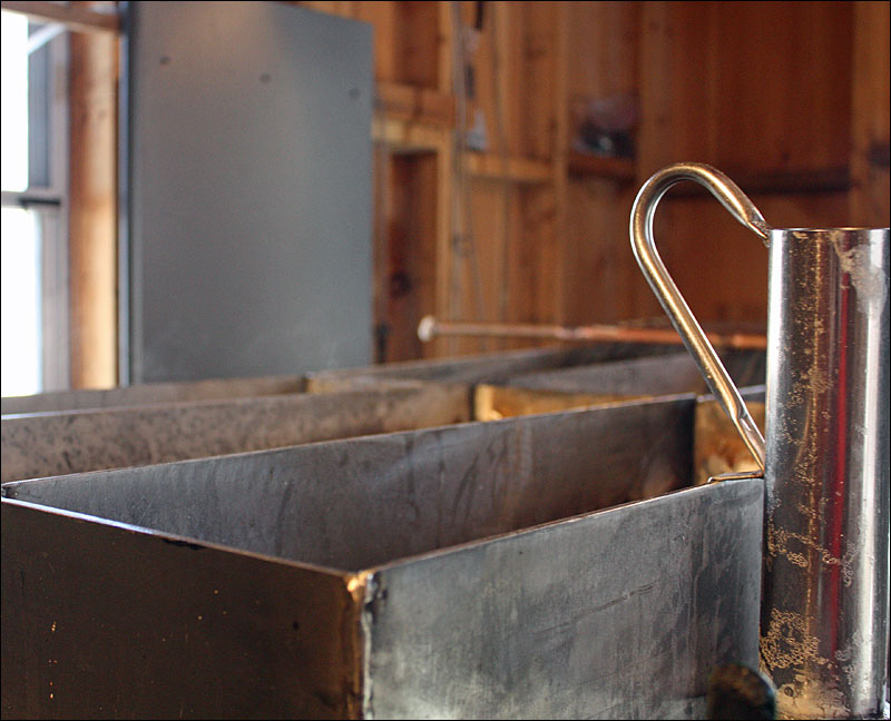 Tom Cox has to keep what little bit of sap he has in his extractor warm to keep the whole unit from freezing and possibly breaking, or requiring a dissasembly, which will set him back once his stored sap melts and can be fed into the extractor, and the sap in the 400 tree taps he has starts flowing too. (Photo by Holly S. Edwards)