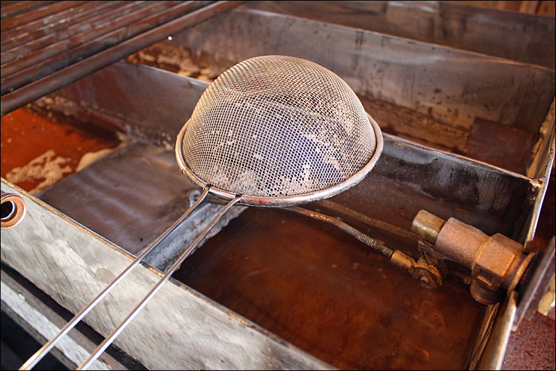Tom Cox’s maple syrup operation is all handmade with bits of Yankee ingenuity, like the float system he and his friends recently devised to keep the level of sap constant in the evaporator. (Photo by Holly S. Edwards)