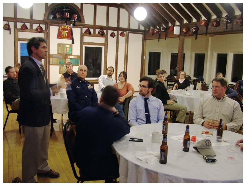 Capt. David Gelinas of the Penobscot Bay and River Pilots Association, left, urges members of the Propeller Club to attend hearings and public meetings on the proposed dredging or risk losing Searsport’s viability as a commercial port. (Photo by Ethan Andrews)