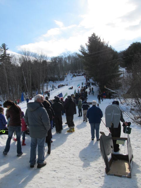 The crowds line up on the Tube Hill to watch the racers come down. (Photo by Kay Stephens)
