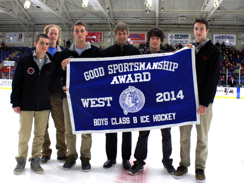 Members of the Camden Hills Regional High School ice hockey team, from left, Nick Czuchra, team co-captain Parker Lawson, team co-captain Jack Orne, head coach Karl Enroth, a player and Jet Magri hold up the Good Sportsmanship banner for Western Class B at the State Championship game at the Colisee in Lewiston March 8. (Courtesy Camden Hills Regional High School)