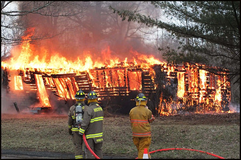 Firefighters work from a distance to control the final fire allowed to consume the home on Route 90, donated for training. (Photo by Chris Wolf)